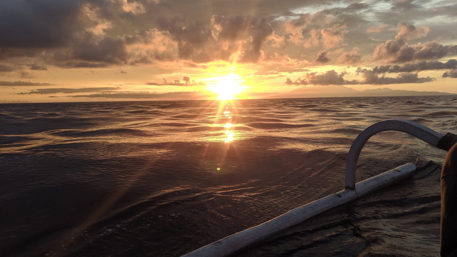 Sunrise seen from a jukung boat in Amed