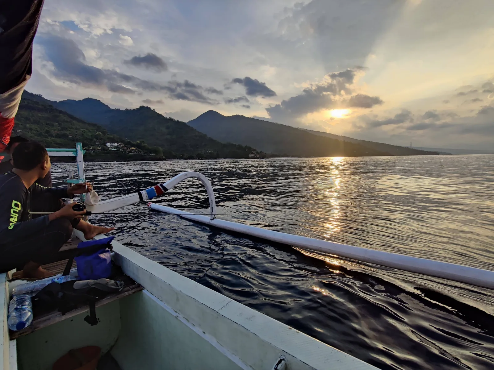 Traditional handline fishing from a jukung boat in Amed